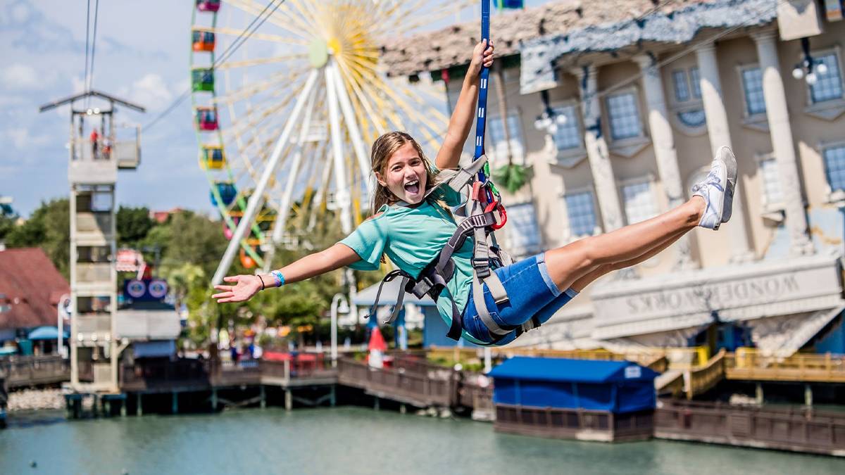 woman on zipline across lake at Soar + Explore in Myrtle Beach, South Carolina, USA
